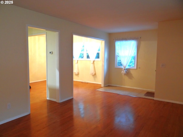 unfurnished room with hardwood / wood-style floors