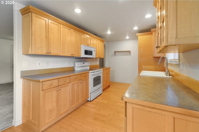 kitchen featuring sink, light brown cabinetry, white appliances, and light wood-type flooring