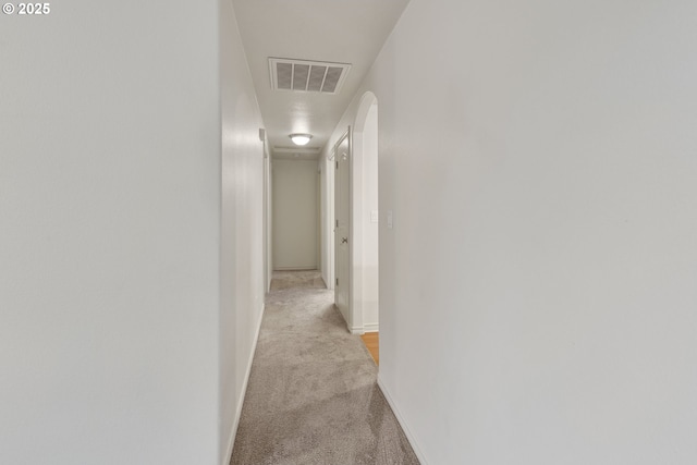 hallway with light colored carpet