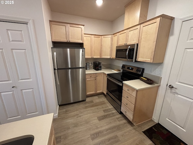 1690 32nd St, Florence, OR 97439 - kitchen with stainless steel appliances, light brown cabinets, light wood finished floors, and light countertops