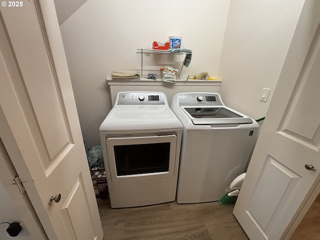 1690 32nd St, Florence, OR 97439 - laundry room with washer and clothes dryer and wood finished floors