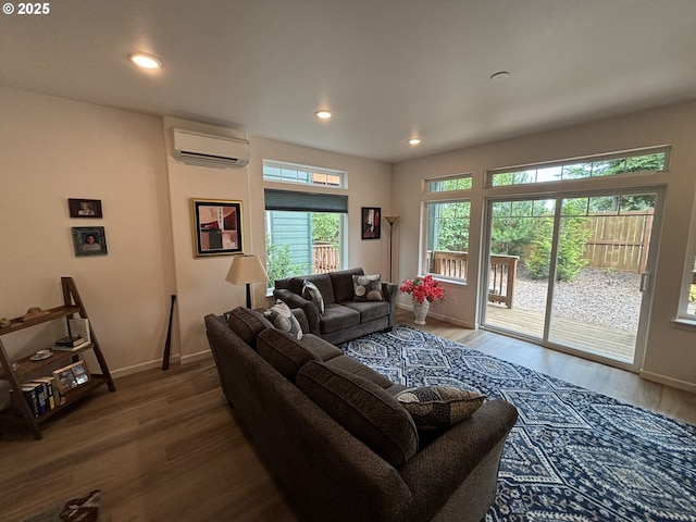 1690 32nd St, Florence, OR 97439 - living room featuring a wall unit AC, wood finished floors, and recessed lighting