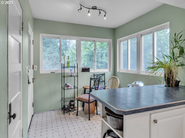 dining area featuring light floors and rail lighting