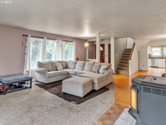 living room with stairs and light wood-type flooring