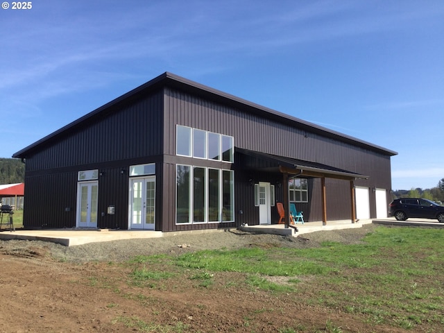 rear view of property with a lawn and a patio area