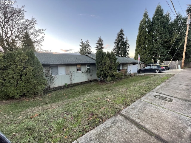 view of side of property with a garage and a yard