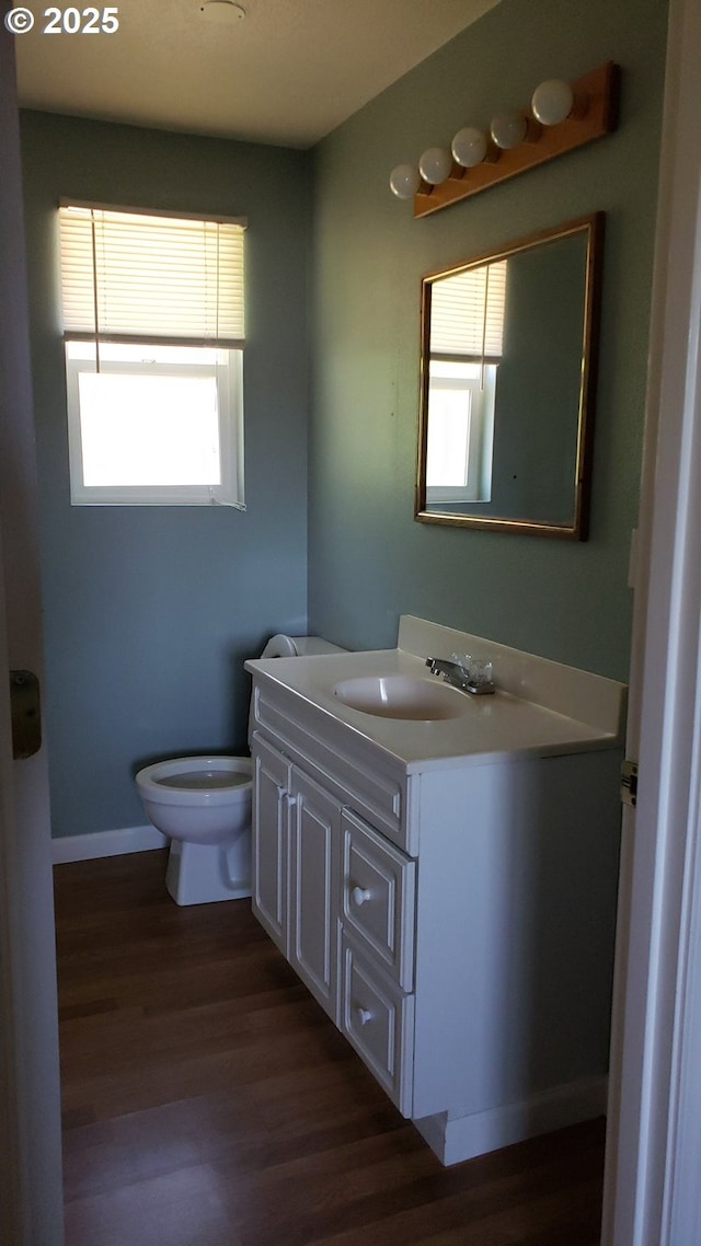 bathroom featuring hardwood / wood-style floors, vanity, and toilet