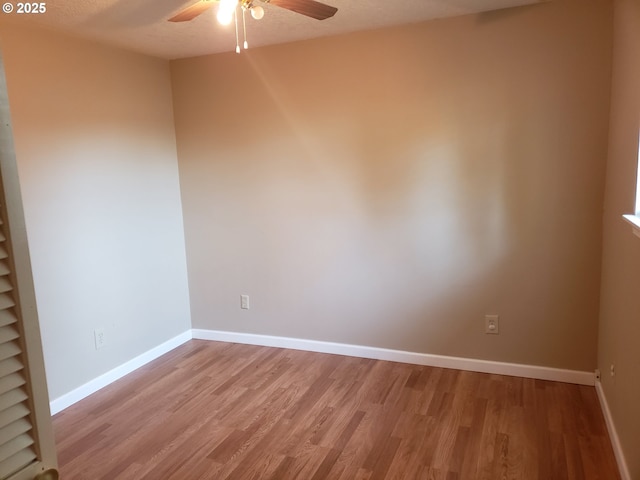 empty room with ceiling fan, light hardwood / wood-style flooring, and a textured ceiling