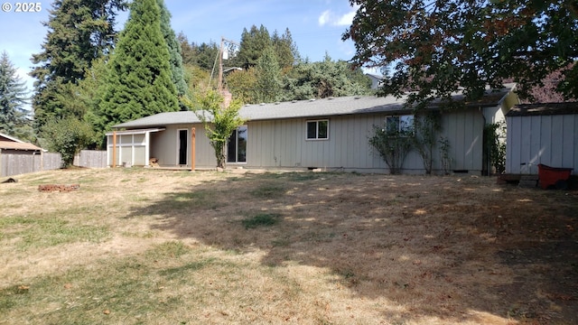 rear view of house with a yard