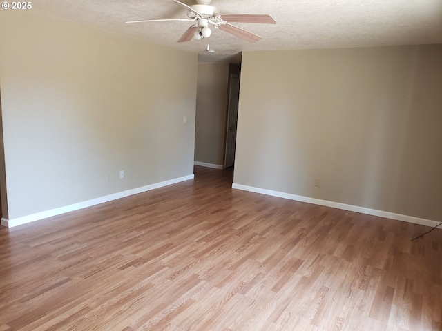 spare room with ceiling fan, a textured ceiling, and light hardwood / wood-style flooring