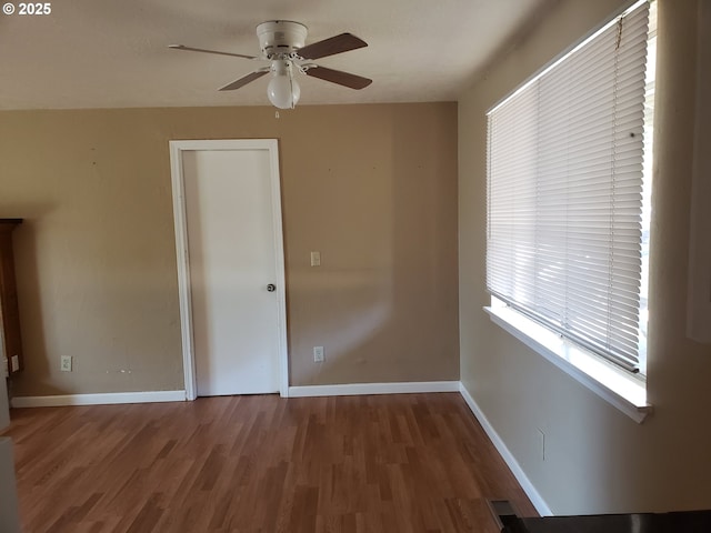 empty room with ceiling fan and wood-type flooring