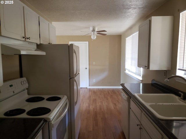 kitchen with white cabinets, white electric range, stainless steel dishwasher, and sink