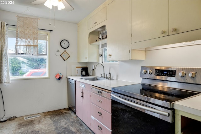 kitchen with visible vents, ceiling fan, a sink, light countertops, and appliances with stainless steel finishes