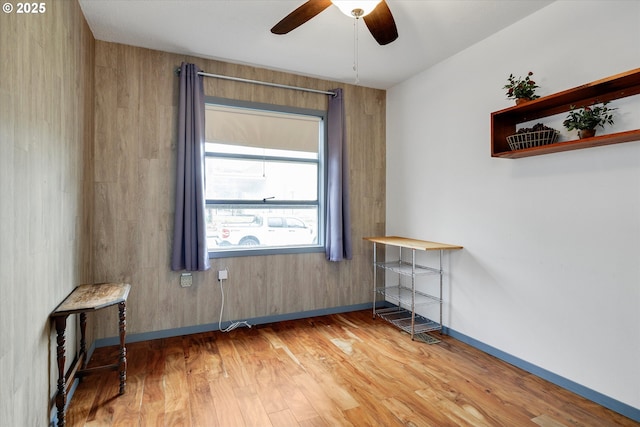 unfurnished room with light wood-style flooring, baseboards, and a ceiling fan