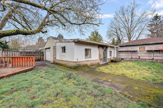 exterior space featuring a lawn, an outdoor structure, and fence