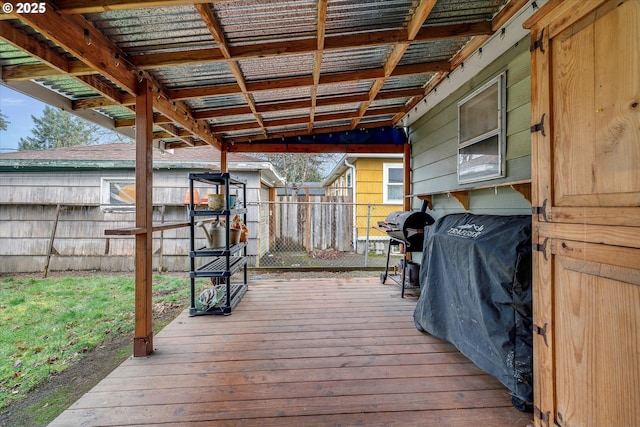 deck with area for grilling and fence