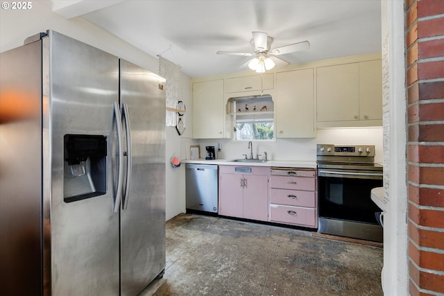 kitchen with ceiling fan, a sink, light countertops, cream cabinetry, and appliances with stainless steel finishes