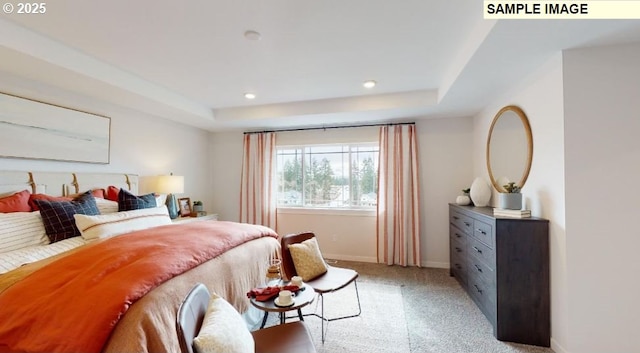 carpeted bedroom with a tray ceiling