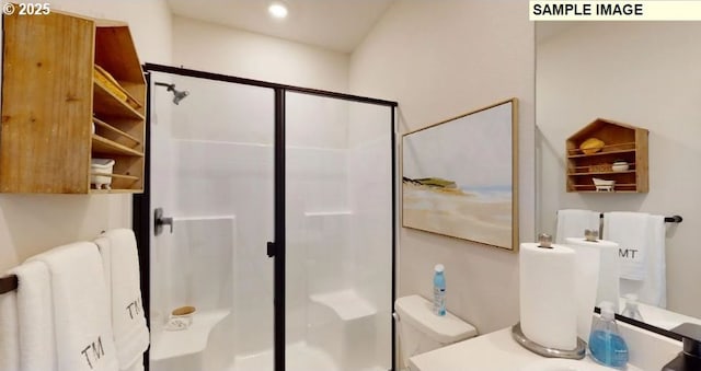 bathroom featuring toilet and walk in shower