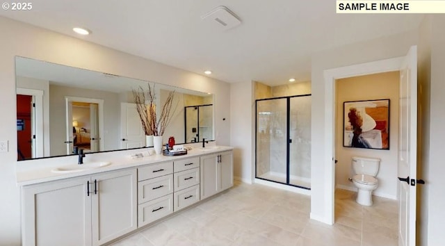 bathroom featuring vanity, toilet, and a shower with door