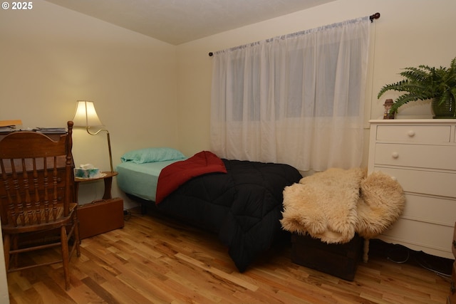 bedroom featuring vaulted ceiling and wood finished floors