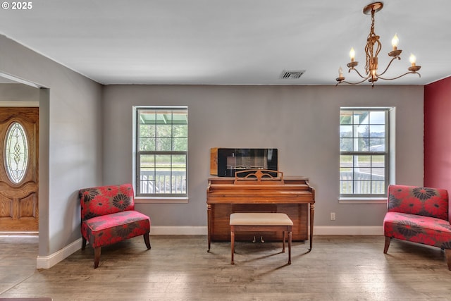 222 Twin Springs Ln, Roseburg, OR 97470 - living area featuring healthy amount of natural light, a chandelier, wood finished floors, and baseboards