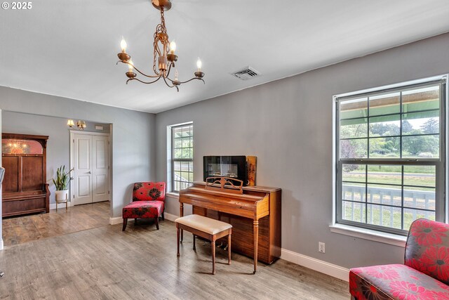 222 Twin Springs Ln, Roseburg, OR 97470 - sitting room featuring a chandelier, light wood-style floors, and baseboards