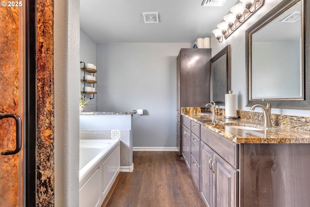 222 Twin Springs Ln, Roseburg, OR 97470 - full bath featuring wood finished floors, a garden tub, baseboards, and double vanity