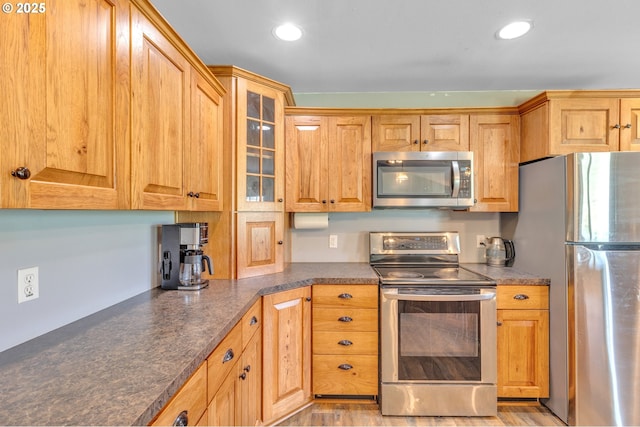 222 Twin Springs Ln, Roseburg, OR 97470 - kitchen with appliances with stainless steel finishes, dark countertops, glass insert cabinets, and recessed lighting