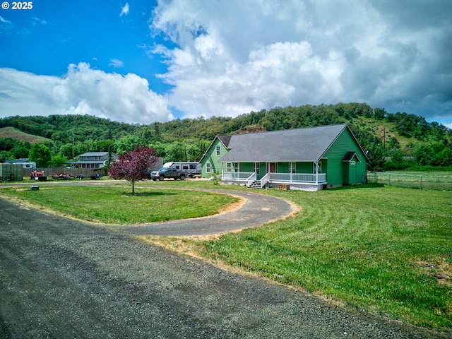 222 Twin Springs Ln, Roseburg, OR 97470 - view of front facade featuring covered porch, driveway, and a forest view