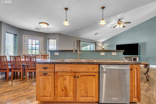 222 Twin Springs Ln, Roseburg, OR 97470 - kitchen featuring stainless steel dishwasher, a sink, light wood-type flooring, vaulted ceiling, and dark countertops