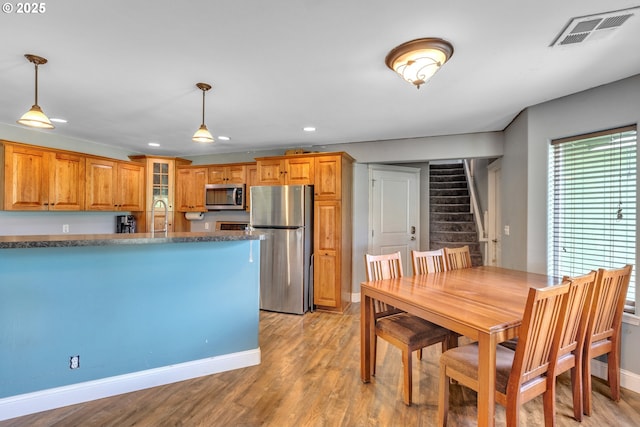 222 Twin Springs Ln, Roseburg, OR 97470 - kitchen featuring appliances with stainless steel finishes, recessed lighting, a sink, pendant lighting, and brown cabinetry