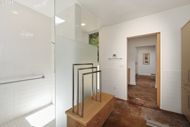 bathroom featuring tile walls and wainscoting