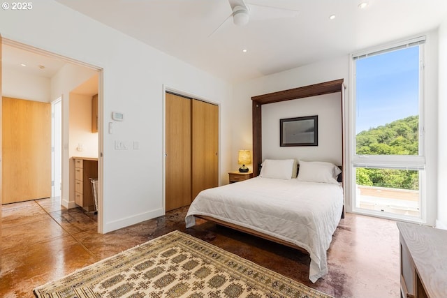 bedroom with concrete floors, a closet, baseboards, a ceiling fan, and recessed lighting