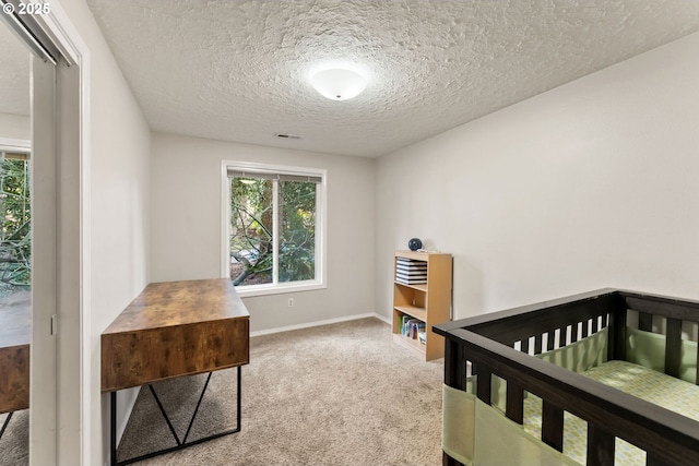 carpeted bedroom with visible vents, multiple windows, a textured ceiling, and baseboards