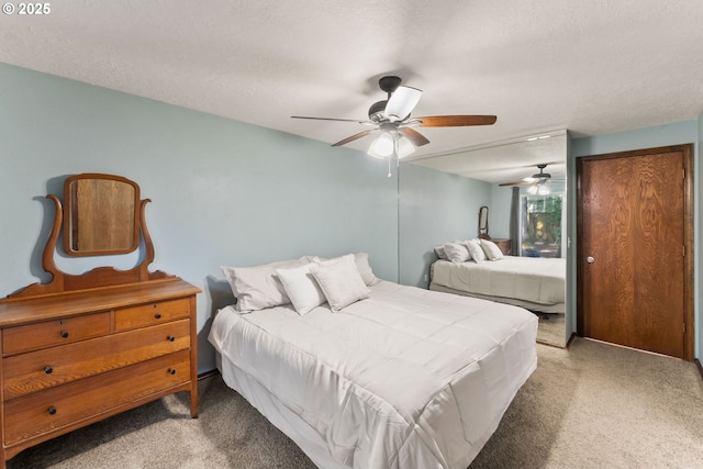 bedroom featuring a textured ceiling, ceiling fan, and carpet floors