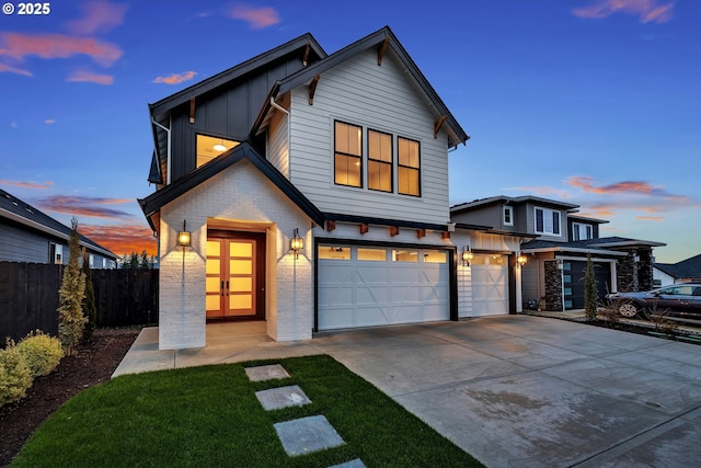 view of front of home featuring concrete driveway, board and batten siding, fence, and an attached garage