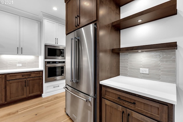 kitchen featuring backsplash, light countertops, open shelves, and stainless steel appliances