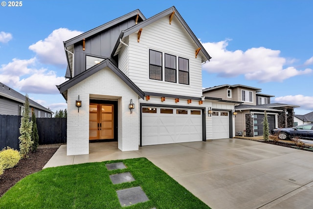 view of front of property with board and batten siding, a garage, fence, brick siding, and driveway
