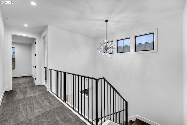 stairway featuring recessed lighting, carpet, a notable chandelier, and baseboards