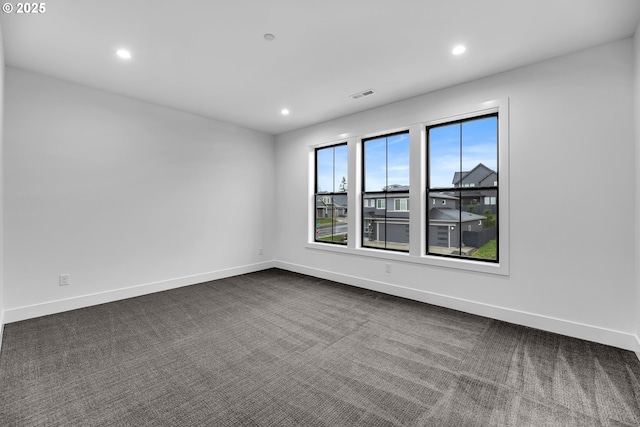 unfurnished room featuring visible vents, recessed lighting, and dark colored carpet