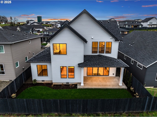 back of house with a patio area, a residential view, a fenced backyard, and a shingled roof