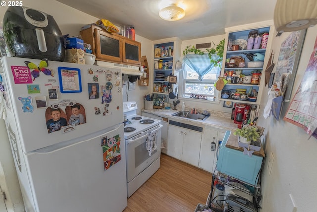 kitchen with white appliances, light wood finished floors, white cabinets, open shelves, and a sink