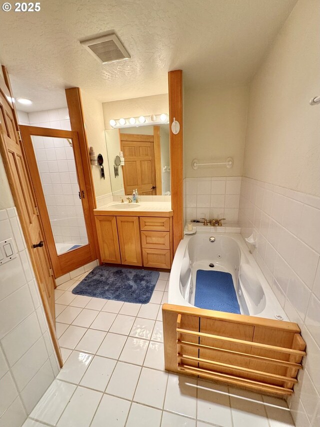 31640 Spruce Dr, Gold Beach, OR 97444 - bathroom with a textured ceiling, visible vents, a stall shower, and a whirlpool tub