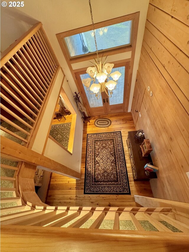 31640 Spruce Dr, Gold Beach, OR 97444 - entryway featuring a high ceiling, a skylight, wood walls, and a chandelier