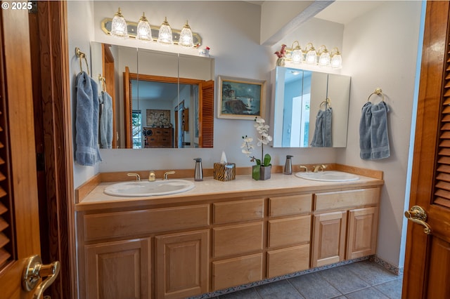 bathroom featuring tile patterned flooring, a sink, and double vanity