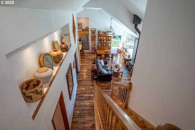 corridor featuring vaulted ceiling and dark wood finished floors