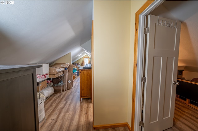 bonus room with vaulted ceiling and wood finished floors