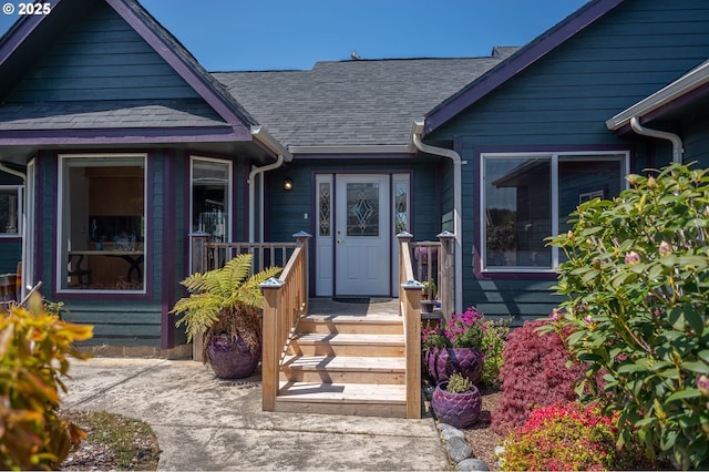 entrance to property with a shingled roof