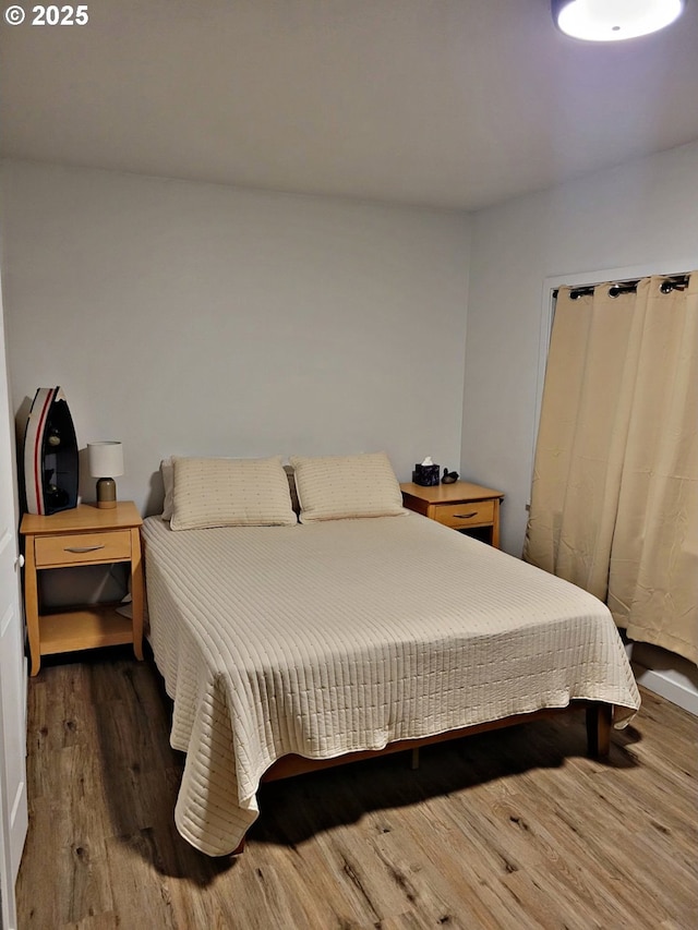 bedroom with dark wood-type flooring